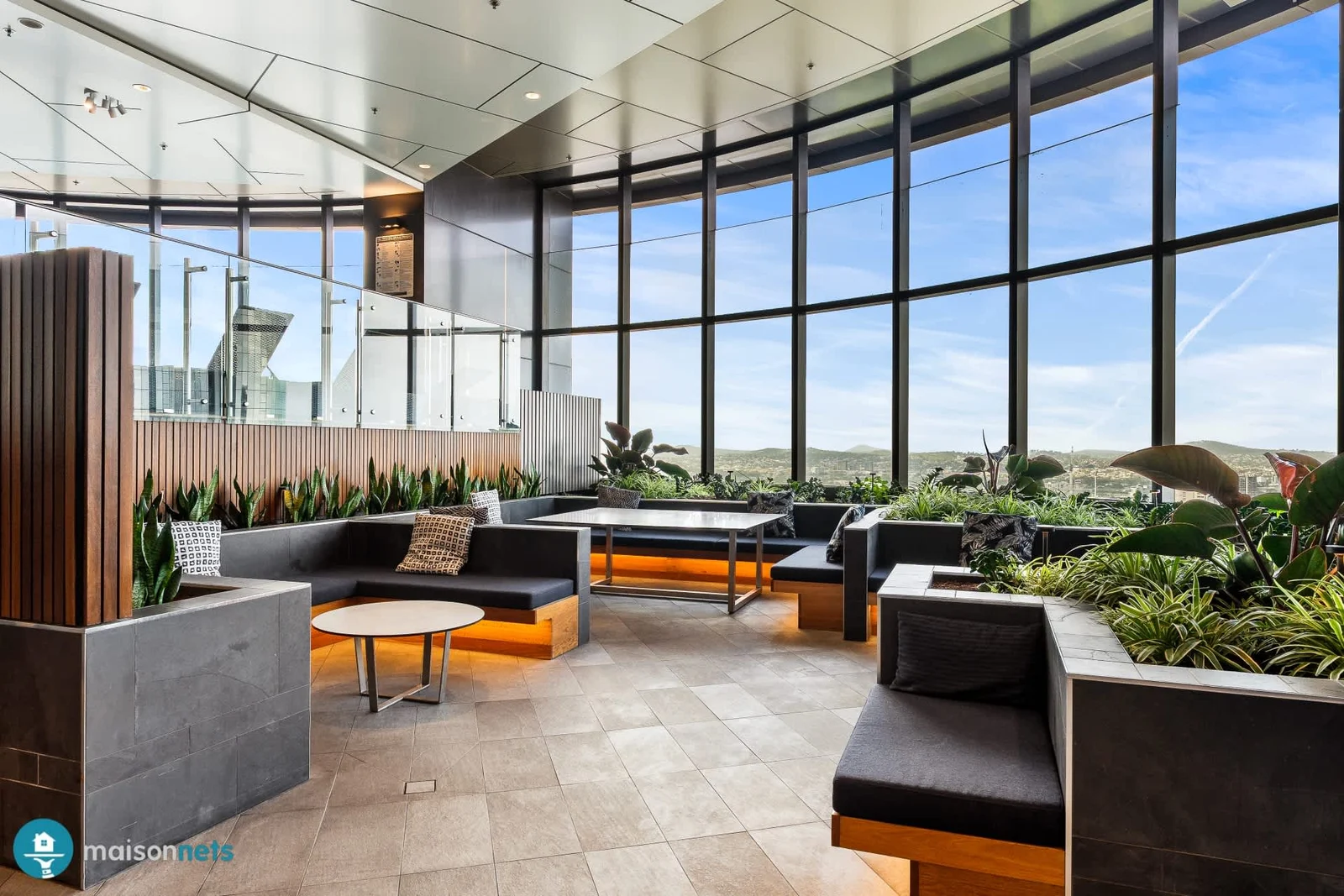 Resort-style recreational deck with lounge seating and panoramic city views